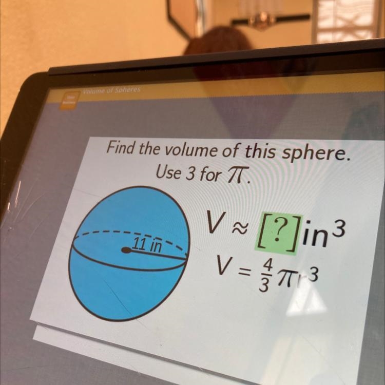 Hi i need help please Find the volume of this sphere. Use 3 for TT. V 11 in V ~ [?]in-example-1