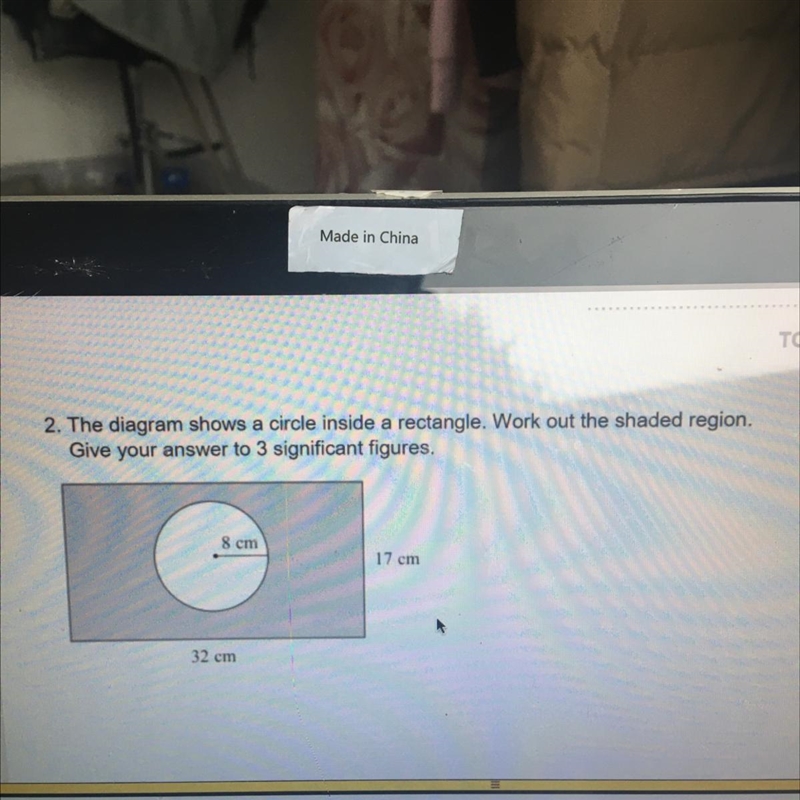 2. The diagram shows a circle inside a rectangle. Work out the shaded region, Give-example-1