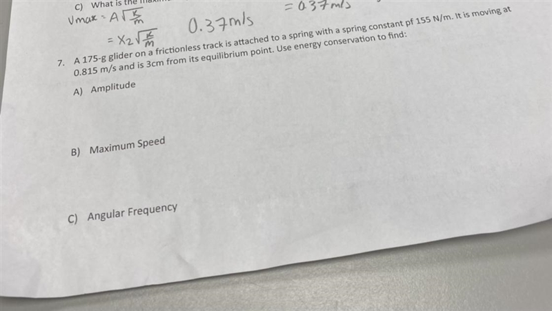 A 175-g glider on a frictionless track is attached to a spring with a spring constant-example-1