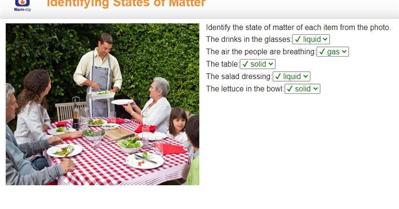 A family sits around a table eating a meal. The table holds glasses with clear material-example-1