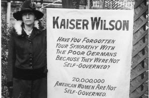 What cause does this woman support? How is the banner critical of Woodrow Wilson?-example-1